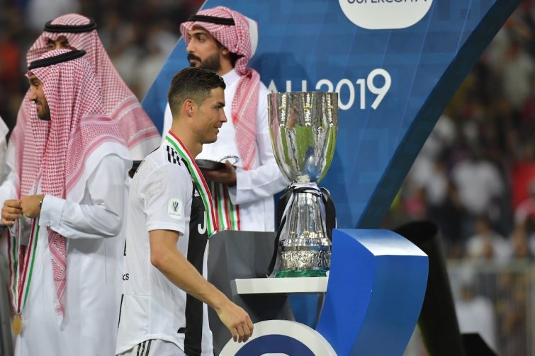 Juventus' Portuguese forward Cristiano Ronaldo walks past the Supercoppa Italiana trophy after their final win against AC Milan at the King Abdullah Sports City Stadium in Jeddah on January 16, 2019. (Photo by GIUSEPPE CACACE / AFP)        (Photo credit should read GIUSEPPE CACACE/AFP via Getty Images)